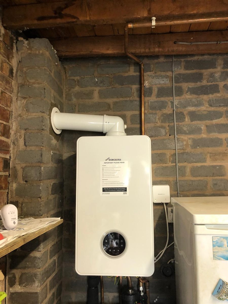 A flue gas analyser reading combustion levels inside an open boiler